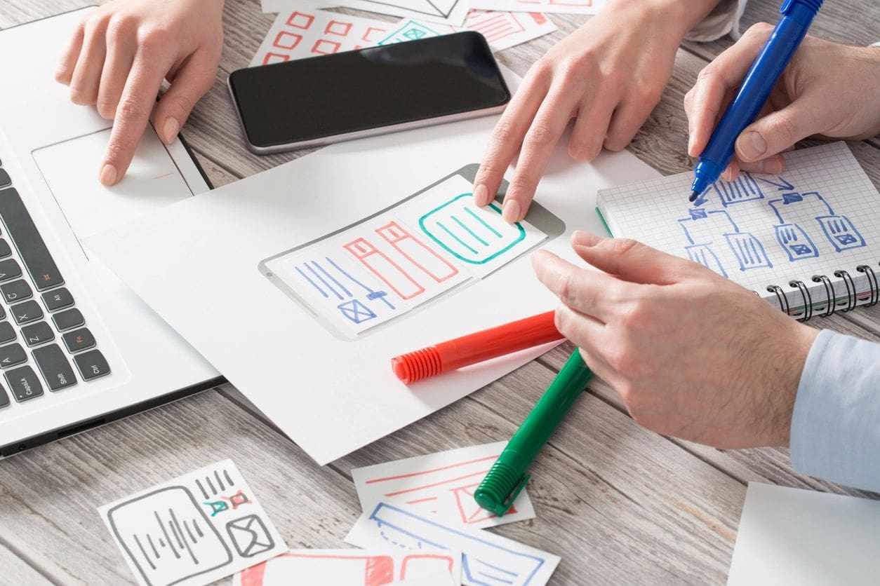 A group of people working on paper designs